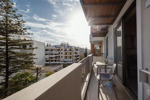a balcony with a table and a view of the city at 7 City Luxury Apartments in Rethymno Town