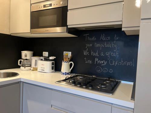 a kitchen with a stove and a sign on the wall at Il Fiorino di Badia in Badia A Passignano