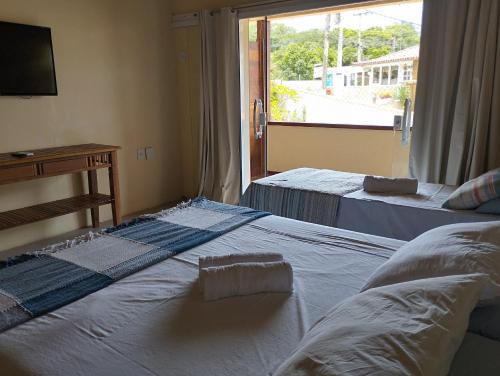 Postel nebo postele na pokoji v ubytování Andorinhas Suites