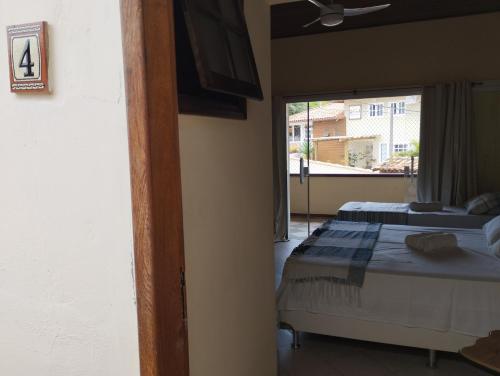Postel nebo postele na pokoji v ubytování Andorinhas Suites