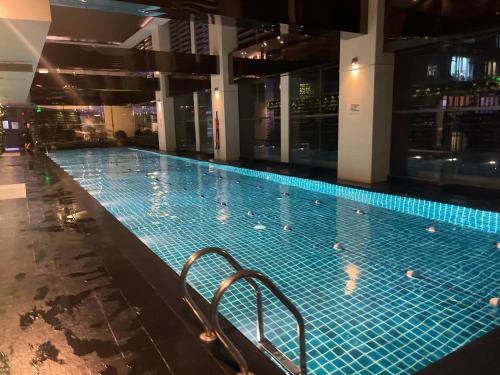 a large swimming pool in a building at Spacious Loft in Gramercy in Manila