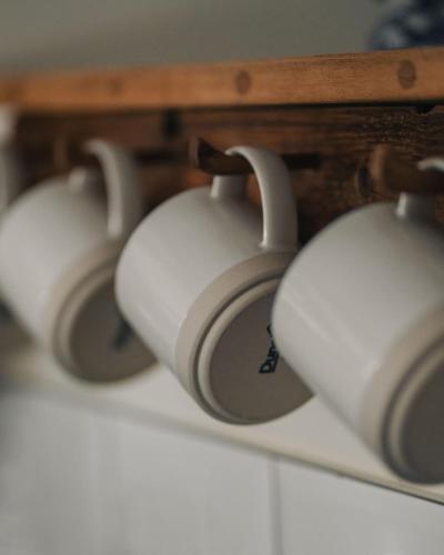 a row of white headphones sitting on a shelf at Swallows Nest in Bude
