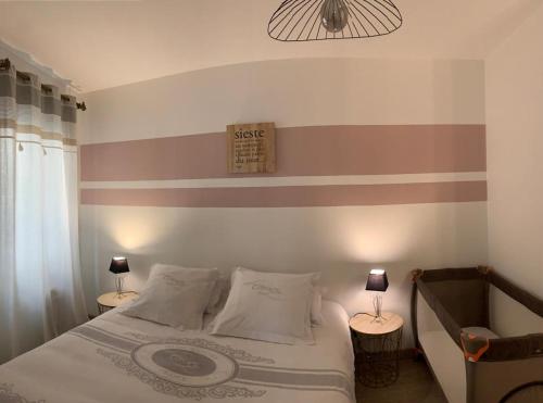 リル・シュル・ラ・ソルギュにあるLa Sorguetteのベッドルーム1室(ストライプの壁のベッド1台付)