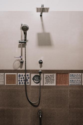 a shower in a bathroom with a shower head at Summer Time Hiriketiya in Dickwella