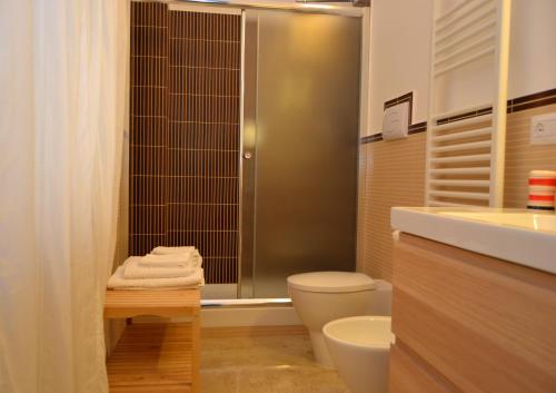 a bathroom with a shower and a toilet and a sink at B&B Re Umberto in Milazzo