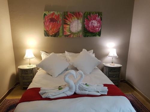 a bed with two towels in the shape of swans at On Golden Pond - Mount Amanzi in Hartbeespoort