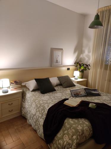 a bedroom with a bed and two tables and two lamps at Borgo di Arcadia in Porto Tolle