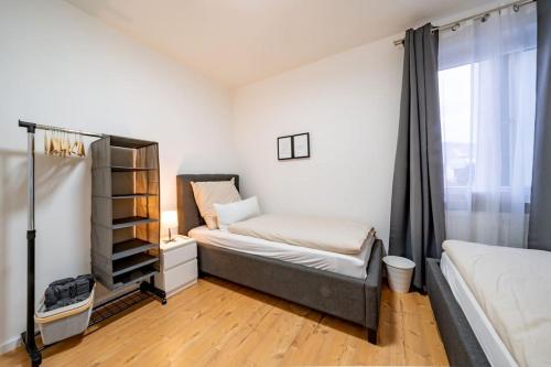 um pequeno quarto com 2 camas e uma janela em Modernisiertes Altbau 3-Zi Apartment em Rinteln