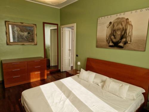 a bedroom with a bed and a picture of an elephant on the wall at Cozy flat mins walk to Navigli and metro Porta Genova in Milan