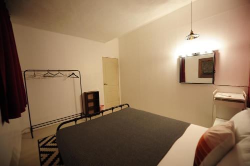 a small bedroom with a bed and a mirror at IM Santai Lodge in Kangar