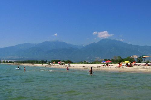 a group of people playing in the water at a beach at Hotel Villa Drosos in Litochoro