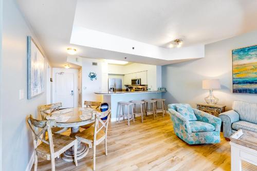 a living room with a table and chairs at Shores of Panama 1517 in Panama City Beach