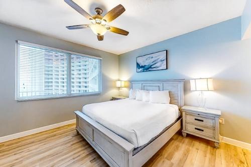 a bedroom with a bed and a ceiling fan at Shores of Panama 1517 in Panama City Beach