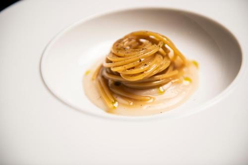 a white bowl of peanut butter and caramel sauce at Magari Estates Boutique Hotel in Colognola ai Colli