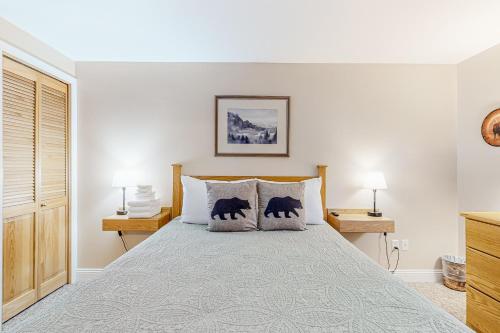 a bedroom with a bed with two pillows on it at Northwoods Lodge Cabin 1 in Morrisville