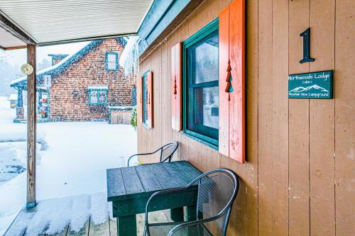 a bench sitting on the side of a house at Northwoods Lodge Cabin 1 in Morrisville