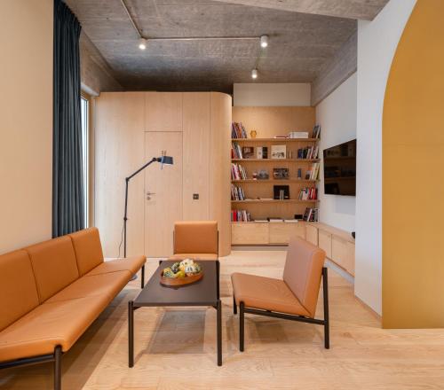 a living room with a couch and chairs and a table at Rosetti Hotel in Bucharest