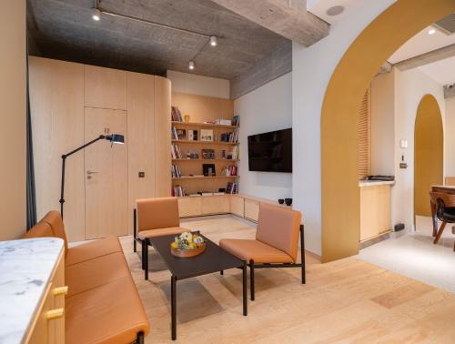 a living room with a table and chairs at Rosetti Hotel in Bucharest