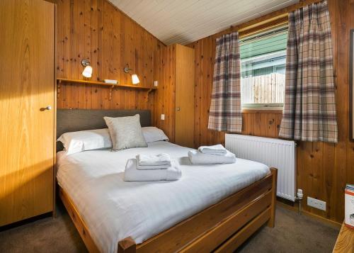 a bedroom with a bed with two towels on it at Hartsop Fold in Patterdale