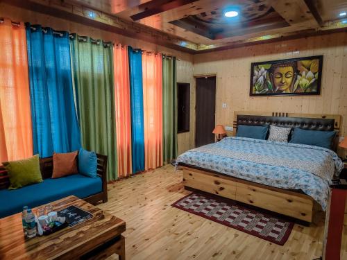 a bedroom with a bed and a couch at The Alpinist cafe and Retreat in Kaza