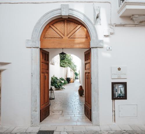 an entrance to a white building with a wooden door at PALAZZO FRANGIPANE in Salve