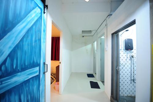a corridor of a hospital with a blue door at IM Santai Lodge in Kangar