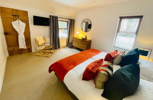 a bedroom with a large bed and a couch at Stag's Hide in Aviemore