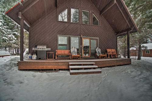 a house with a deck in the snow at Beautiful McCall Cabin Perfect for Families! in McCall