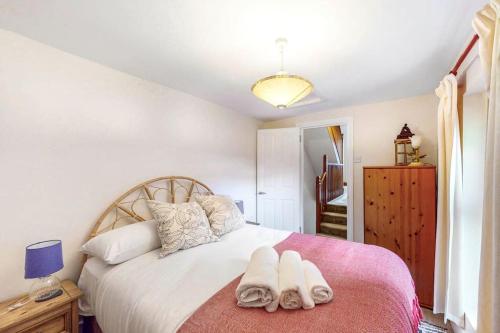 a bedroom with a bed with two towels on it at Beautiful two bedroom apartment in Honor Oak in London