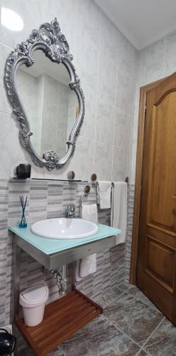 a bathroom with a sink and a mirror at EL RINCÓN DE CHAVELY Estancia minima 2 noches in Palencia