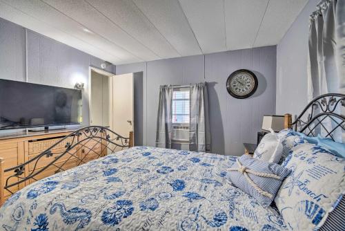 a bedroom with a bed and a clock on the wall at Family-Friendly Yankeetown Home with Grill! in Yankeetown