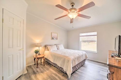 a bedroom with a bed and a ceiling fan at Eufaula Escape with Deck - Steps to Lake! in Eufaula