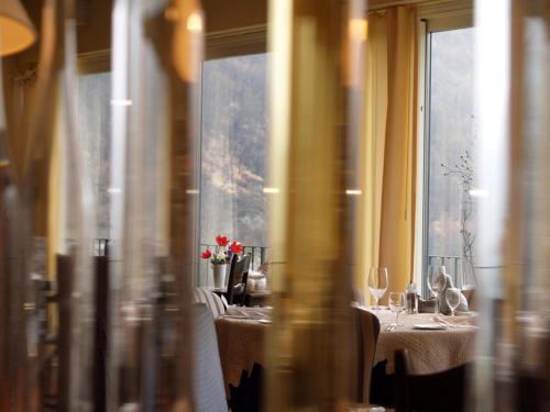 a restaurant with two tables with flowers on them at Ristorante della Stazione da YanElo in Intragna