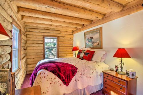 a bedroom with a bed and a wooden wall at Pine Mountain Club Log Home with Deck and Grill! in Pine Mountain Club