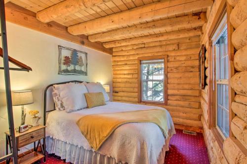 a bedroom with a bed in a log cabin at Pine Mountain Club Log Home with Deck and Grill! in Pine Mountain Club