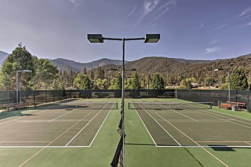 a tennis court with mountains in the background at Pine Mountain Club Log Home with Deck and Grill! in Pine Mountain Club