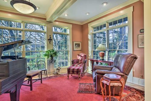 a living room with a piano and chairs and windows at Spacious Hillsboro Home about 18 Mi to Portland! in Hillsboro