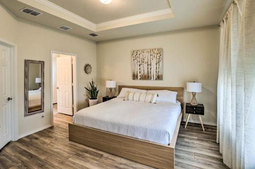 a bedroom with a large bed and a mirror at Sleek Fort Worth Home with Covered Patio! in Fort Worth