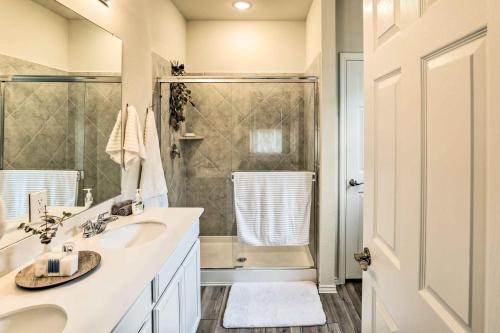 a white bathroom with a shower and a sink at Sleek Fort Worth Home with Covered Patio! in Fort Worth