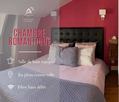 a bedroom with a bed with a red wall at Chambres d'Hôtes Au coin du spa in Boulogne-sur-Mer