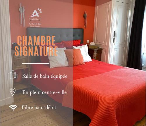 a room with a bed with a red comforter at Chambres d'Hôtes Au coin du spa in Boulogne-sur-Mer