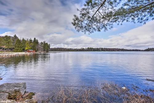 a large body of water with trees on the shore at Walk to Lake Harmony Home with Hot Tub and Fire Pit in Lake Harmony