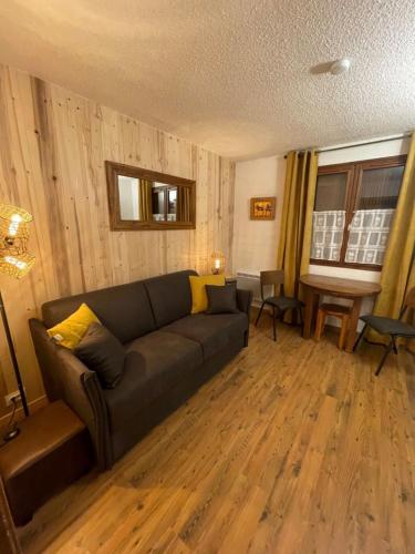 a living room with a couch and a table at Apartment Le Choucas by Interhome in Chamonix