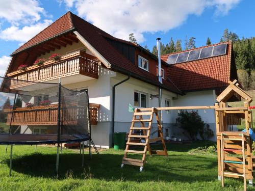 a house with a playground in front of it at Apartment Fischer by Interhome in Eisenbach