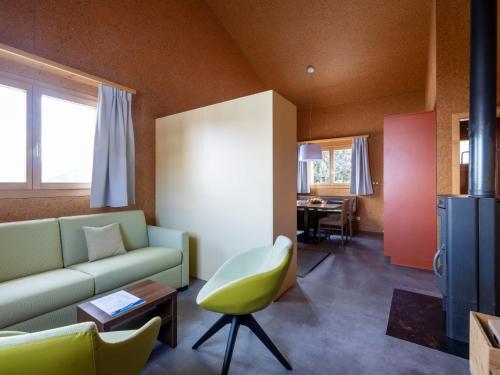 a living room with a couch and a chair at Holiday Home Maiensäss Komfort by Interhome in Urmein