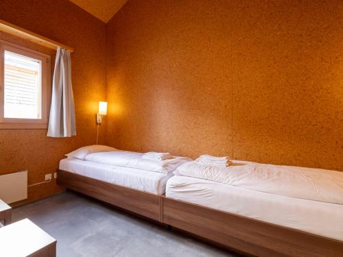 a bedroom with two beds in a room at Holiday Home Maiensäss Komfort by Interhome in Urmein