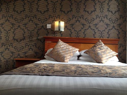 a bedroom with a bed with two pillows on it at Grainger Hotel in Newcastle upon Tyne