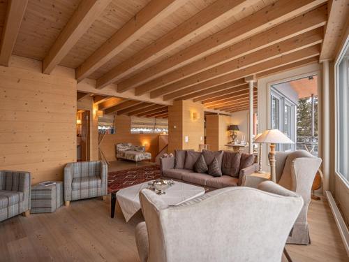 a living room with a couch and a table at Apartment Chesa Crusch 7 by Interhome in Samedan