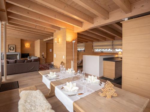 a living room with a dining table and a kitchen at Apartment Chesa Crusch 7 by Interhome in Samedan