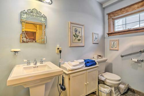 a bathroom with a sink and a toilet and a mirror at Charming Saint Paul Home with Yard, Near Downtown! in Saint Paul